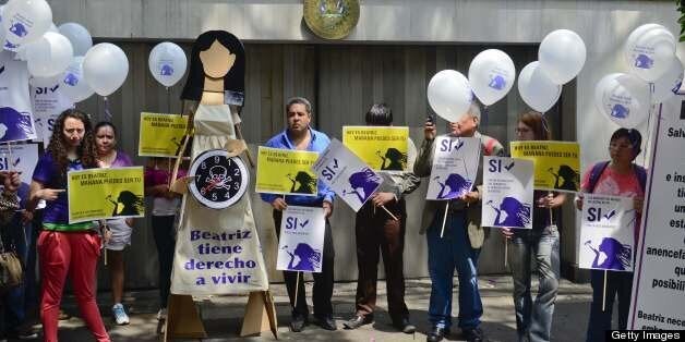 Members of Amnesty International protest in front of the El Salvador embassy in Mexico city, on May 29, 2013. Amnesty protest against the government of El Salvador by not allowing the abortion of Beatriz, a 22-year-old woman, pregnant with a baby without a brain. AFP PHOTO/RONALDO SCHEMIDT (Photo credit should read Ronaldo Schemidt/AFP/Getty Images)