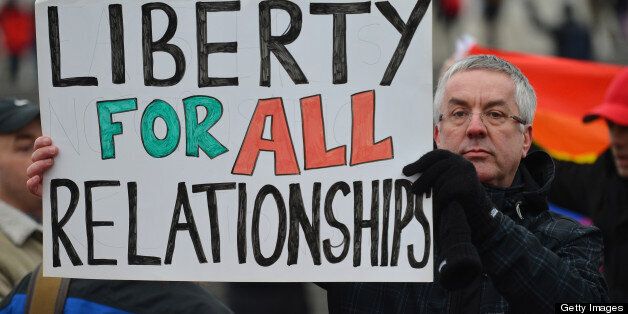 A protester holds up a placard that reads 'Liberty for all relationships' as he joins a demonstration for equal rights for gay couples in Trafalgar Square cental London on March 24, 2013 countering an Anglo-French protest against a controversial bill to legalise same-sex marriage and adoption in France. France's National Assembly endorsed thebill to legalise same-sex marriage and adoption on February 12. The bill still has to go to the Senate for examination and approval, but the upper house is unlikely to prevent the groundbreaking reform from becoming law by the summer. AFP PHOTO / BEN STANSALL (Photo credit should read BEN STANSALL/AFP/Getty Images)