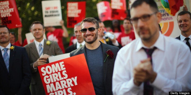 LONDON, ENGLAND - JUNE 03: Proponents of same sex marriage sing during a vigil outside the Houses of Parliament on June 3, 2013 in London, England. A government bill allowing same sex marriage in England and Wales was passed in the House of Commons last month, despite the opposition of 133 Conservative MP's. The bill is currently being debated in the House of Lords. (Photo by Dan Kitwood/Getty Images)