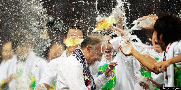 SAITAMA, JAPAN - JUNE 04: Alberto Zaccheroni Head Coach of Japan is soaked by players after the FIFA World Cup qualifier match between Japan and Australia at Saitama Stadium on June 4, 2013 in Saitama, Japan. (Photo by Adam Pretty/Getty Images)
