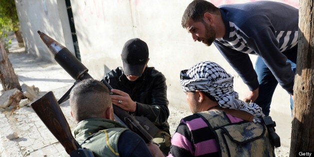 Rebel fighters prepare to launch of a rocket in the Saif al-Dawla district of the northern Syrian city of Aleppo, on April 21, 2013. Syria's National Coalition head Ahmad Moaz al-Khatib has refiled his resignation and an interim leader is being sought, a fellow member and a source close to the main opposition group said. AFP PHOTO/MIGUEL MEDINA (Photo credit should read MIGUEL MEDINA/AFP/Getty Images)