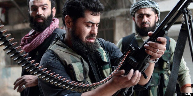 A rebel fighter loads his machine gun during fightings with regime forces on April 1, 2013 in the Sheikh Maqsoud neighbourhood of the Syrian city of Aleppo. AFP PHOTO/GUILLAUME BRIQUET (Photo credit should read Guillaume Briquet/AFP/Getty Images)