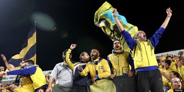 AEL Limassol's fans cheer for their team before the start of the UEFA Europa League group C football match between AEL Limassol and Fenerbahce at GSP Stadium in the Cypriot capital Nicosia on October 25, 2012. AFP PHOTO / BEHROUZ MEHRI (Photo credit should read BEHROUZ MEHRI/AFP/Getty Images)