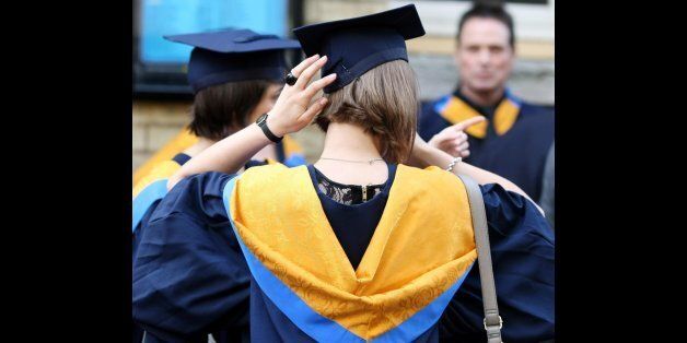 File photo dated 12/10/11 of a general view of students wearing mortar boards and gowns after graduating as university applications have yet to climb back to the levels seen before the tuition fee hike, new data shows.