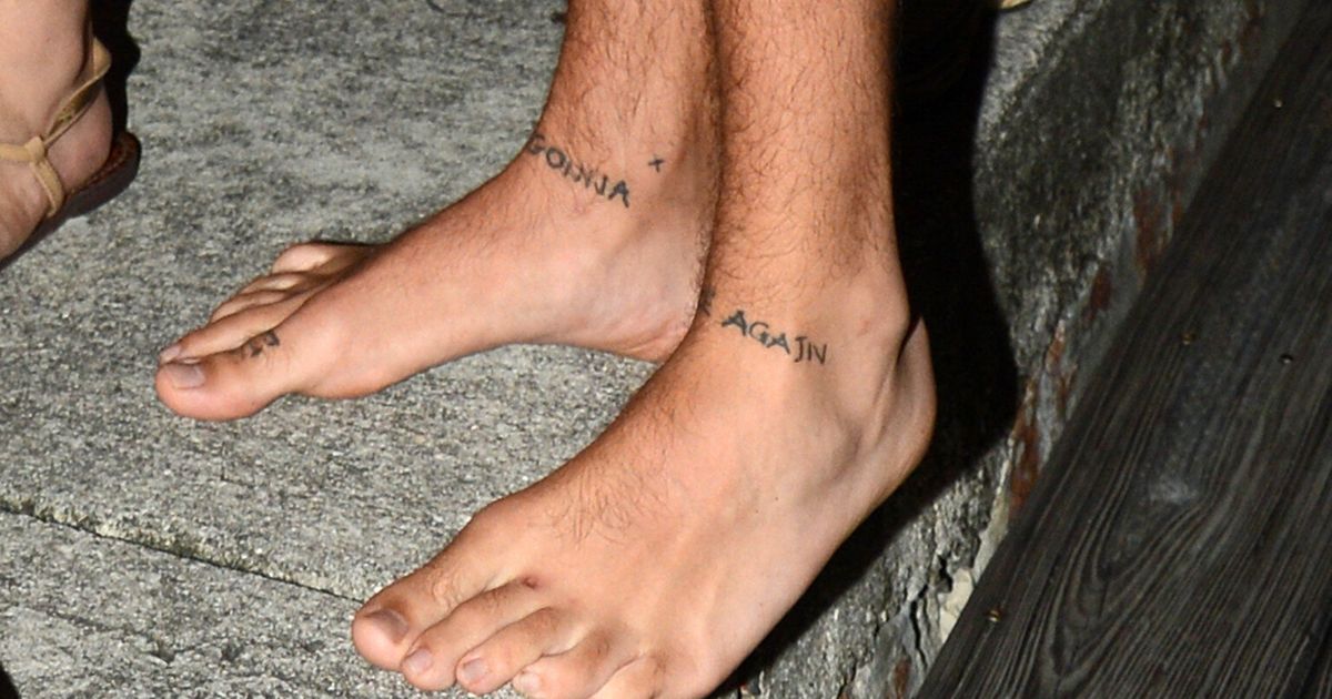...them.The One Direction star showed off his foot art as he walked off a p...