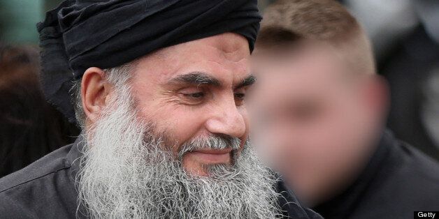 LONDON, UNITED KINGDOM - NOVEMBER 13: (EDITORS NOTE: Part of this image has been obscured following a request from the Metropolitan Police) Muslim Cleric Abu Qatada (L) is watched by a helper as he arrives home after being released from prison on November 13, 2012 in London, England. Abu Qatada was released on bail, having won his appeal against deportation, claiming he would not get a fair trial in Jordan where he is accused of plotting bomb attacks. (Photo by Peter Macdiarmid/Getty Images)