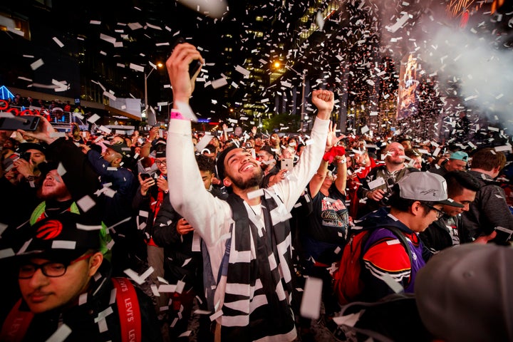 Fans bask in glory outside of Scotiabank Arena in Toronto after the Raptors defeated the Golden State Warriors in Game 6 of the NBA Finals on June 13, 2019.
