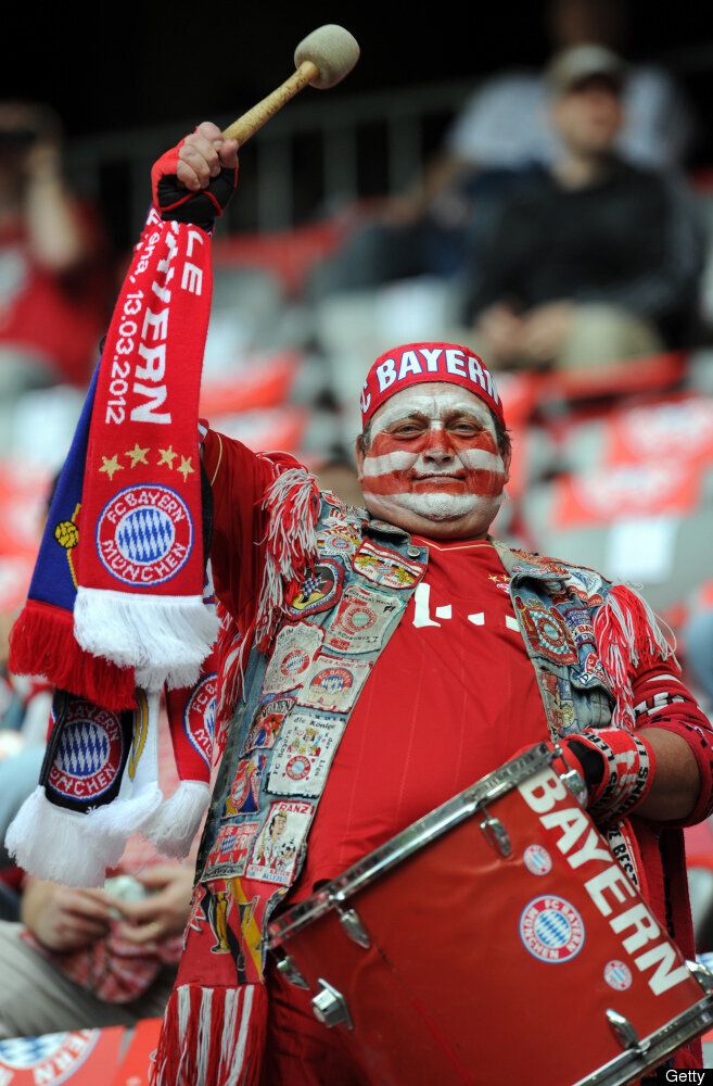 A supporter of Bayern Munich cheers his 
