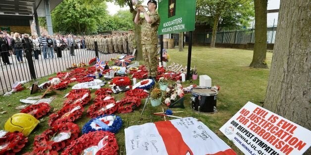 Bugler Dan Griffith plays the last post outside the main gate to Woolwich Barracks in south east London, in memory of Fusilier Lee Rigby, as his funeral takes place at Bury Parish church in Bury, Greater Manchester.