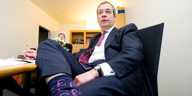 9:30 AM. Leader of UK Independence Party (UKIP) and Member of European Parliament Nigel Farage wears Sterling Pound socks in his office at the European Parliament in Strasbourg, France, on March 12, 2013. Photo by Lucas Schifres/Pictobank/ABACAPRESS. COM