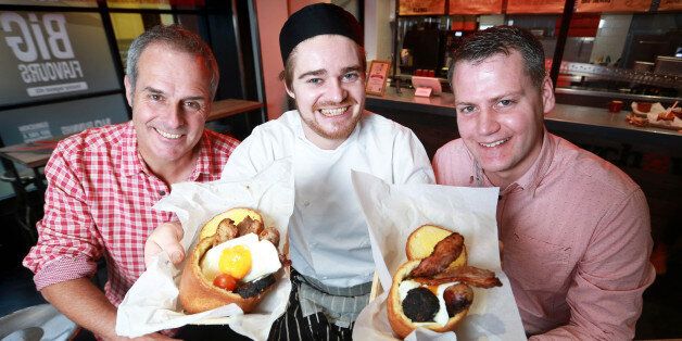 Television chef Phil Vickery (left) presents the 2015 Best Breakfast Award for the UK's Most Innovative Breakfast to Atholl Milton CEO of Bunnychow (right) and Chef Finn Baire (centre), for the Full English Bunny - an individually baked brioche loaf which is hollowed out and filled with sausage, lean bacon, tomatoes, mushrooms, spicy baked beans, black pudding and topped with an egg, at Bunnychow in Wardour Street in London.
