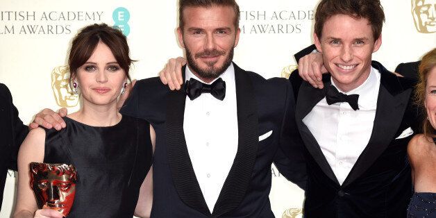 LONDON, ENGLAND - FEBRUARY 08: Presenter David Beckham (C) poses with Felicity Jones (L) and Eddie Redmayne with the Outstanding British Film award for 'The Theory Of Everything' in the winners room at the EE British Academy Film Awards at The Royal Opera House on February 8, 2015 in London, England. (Photo by Karwai Tang/WireImage)