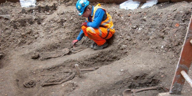 In this undated but recent photo supplied Friday March 15, 2015, by the London Crossrail Project, showing archaeologists working on the UKâs largest infrastructure project, Crossrail, as they uncover an historical burial ground at Charterhouse Square, Farringdon in central London. Scientists were called in to investigate bones found during the digging of a new railway in central London, after uncovered 13 skeletons were found. The skeletons will be tested to see if they died from the Black Death plague which killed between 30 and 60 percent of the European population in the 14th century, and scientist hope to map the DNA signature of the plague bacteria. (AP Photo / Crossrail Project)