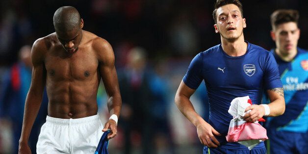 MONACO - MARCH 17: Geoffrey Kondogbia of Monaco and Mesut Oezil of Arsenal swaps shirts at half time during the UEFA Champions League round of 16 second leg match between AS Monaco and Arsenal at Stade Louis II on March 17, 2015 in Monaco, Monaco. (Photo by Michael Steele/Getty Images)