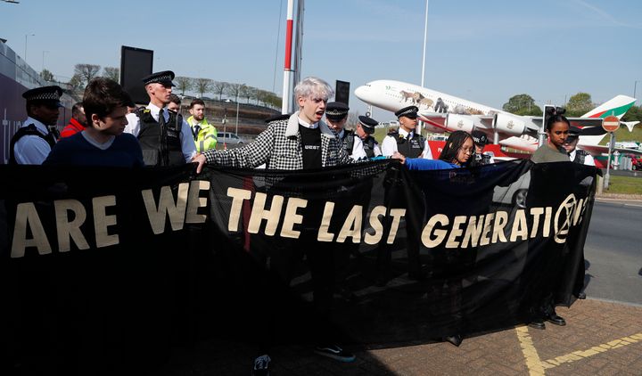 Police surround environmental protestors near Heathrow Airport in London on April 19.