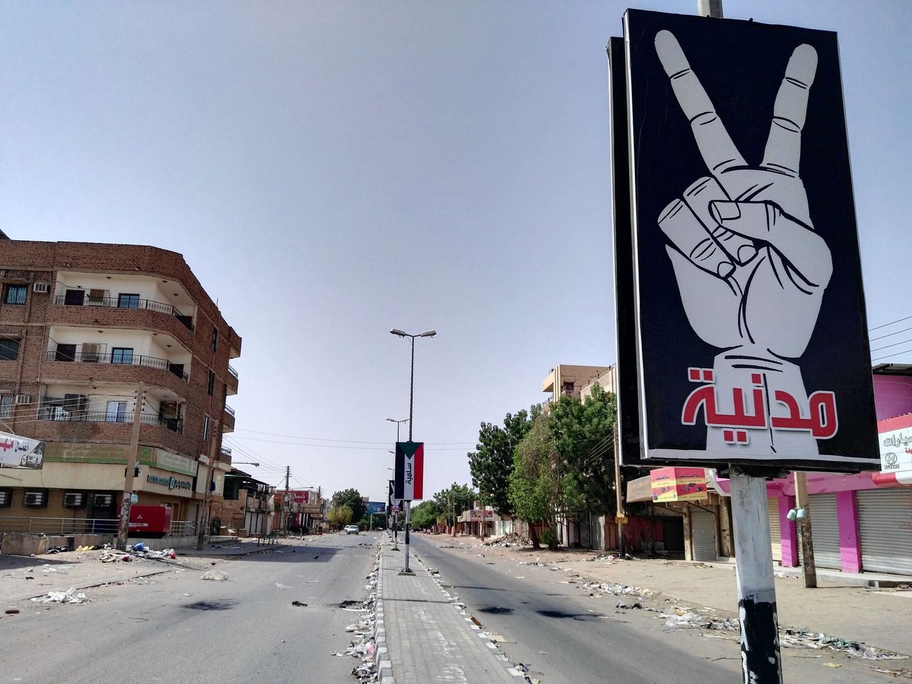 The U.S. has been slow to involve itself in the crisis, while other nations attempt to broker peace. A placard on Street 60 in a nearly deserted Khartoum on June 6 reads: "Civilian and peaceful."