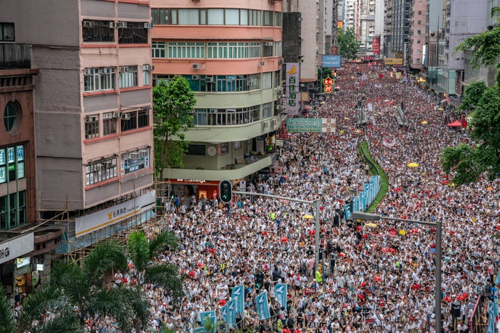 Protesters march on a street during a rally against a controversial extradition law proposal on June 9, 2019 in Hong Kong. Organizers say more than a million protesters marched in Hong Kong against a bill that would allow suspected criminals to be sent to mainland China for trial as tensions have escalated in recent weeks.