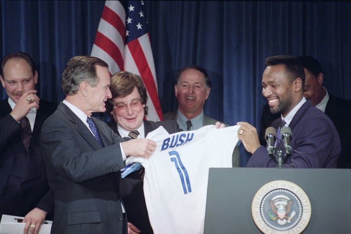 George H. W. Bush, left, accepts a Toronto Blue Jays Jersey from Jays Joe Carter, right, during a ceremony honouring baseball's World Champs at the White House on Dec. 16, 1992.