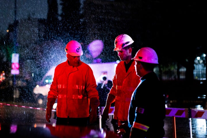 Technicians of Edenor electricity company stand under the rain as they work to fix a generator during a blackout in Buenos Aires, Argentina, Sunday, June 16, 2019. A massive blackout left tens of millions of people without electricity in Argentina, Uruguay and Paraguay on Sunday in what the Argentine president called an “unprecedented” failure in the countries’ power grid.