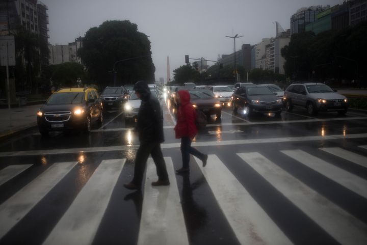 Pedestrians walk in front the Obelisk, during the blackout and under a heavy rain, in Buenos Aires, Argentina, on 16 June 2019. 