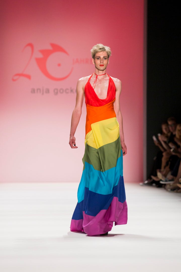 A model wears a rainbow flag dress as he walks the runway at the Anja Gockel show during the spring.summer 2017 Mercedes-Benz Fashion Week in Berlin on June 29, 2016.