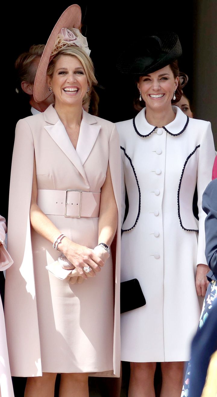 The Netherlands' Queen Maxima and Catherine, Duchess of Cambridge watch the procession to St. George's Chapel.