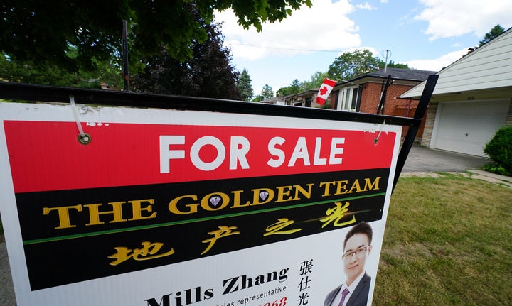 A for-sale sign in front of a house in Toronto, July 24, 2018.