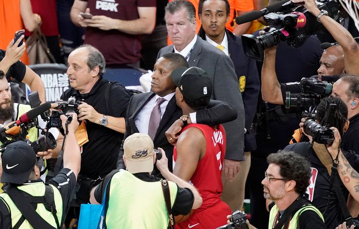 Toronto Raptors general manager Masai Ujiri, centre left, walking with guard Kyle Lowry after the Raptors defeated the Golden State Warriors in Game 6 of basketball's NBA Finals in Oakland, Calif.