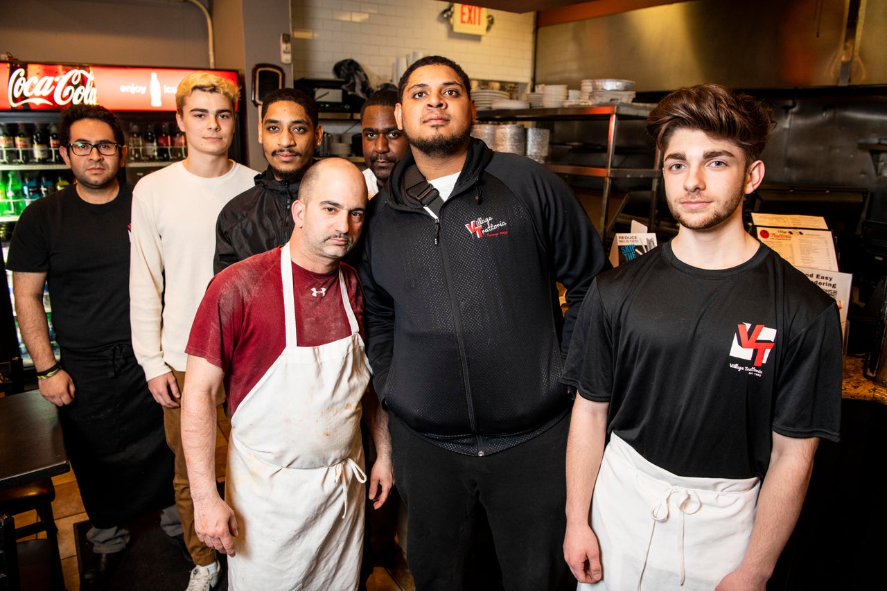 Quinn Butler, second from left, Edward Roman, third from left, and Edwin Roman, sixth from left, with their coworkers at the Village Trattoria in Summit, New Jersey.
