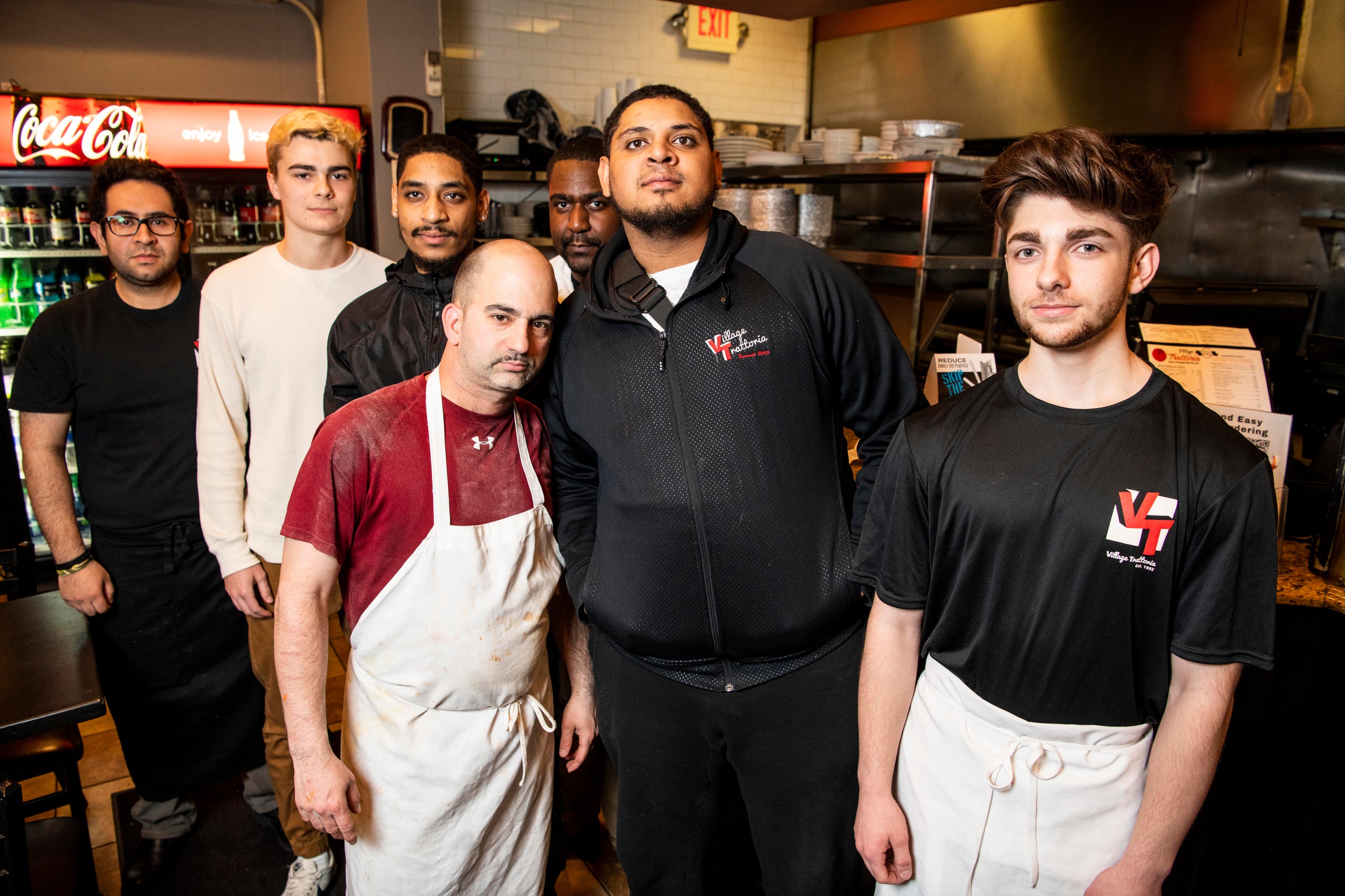 Quinn Butler, second from left, Edward Roman, third from left, and Edwin Roman, sixth from left, with their coworkers at the 