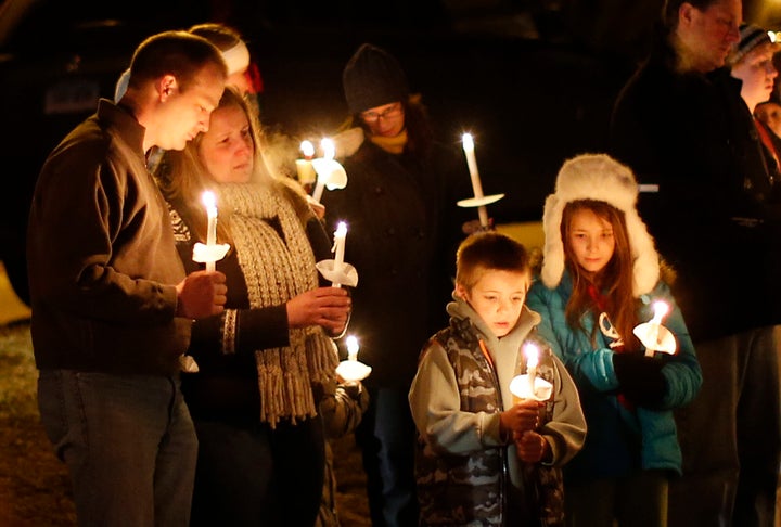 Mourners gather for a candlelight vigil at Ram's Pasture to remember shooting victims, Saturday, Dec. 15, 2012 in Newtown, Conn.