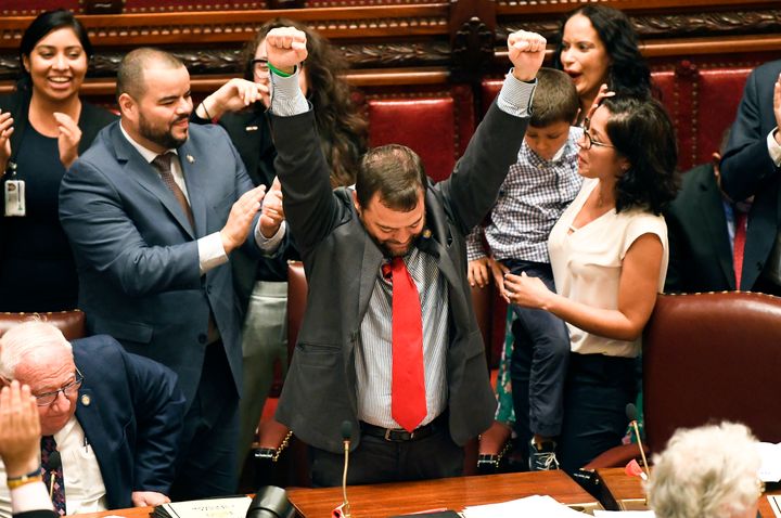 State Sen. Luis R. Sepulveda (D-Bronx), center, celebrates after the Green Light Bill granting undocumented immigrant driver's licenses was passed by the New York State Senate on Monday. Sepulveda was the main sponsor of this legislation.