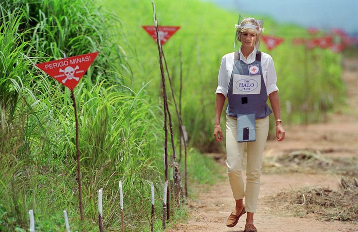 Princess Diana, wearing protective body armour and a visor, visits a landmine minefield being cleared by the charity Halo Trust in Huambo, Angola.