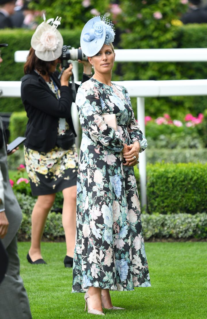 Zara Phillips in a blue hat and blue and pink floral design. 