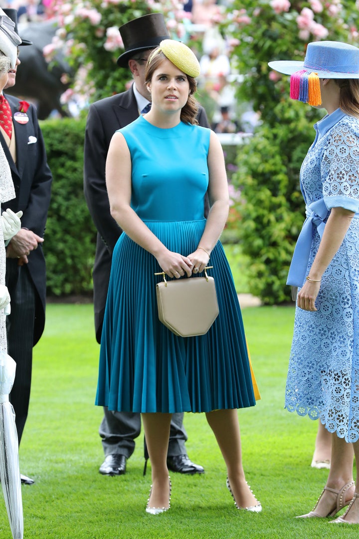 Princess Eugenie paired her teal blue dress with a bright yellow hat and a neutral clutch. 