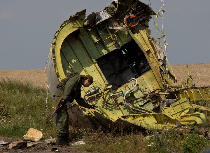 A pro-Russian rebel amid the MH17 wreckage at the crash site of Malaysia Airlines Flight 17, near the village of Hrabove, eastern Ukraine.
