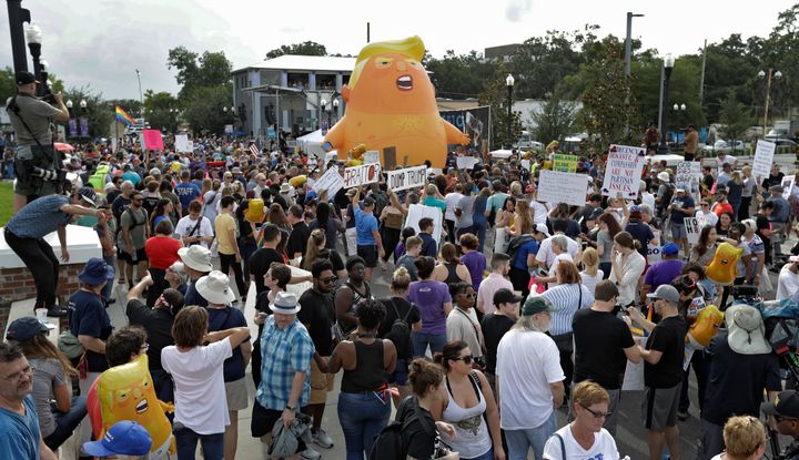 An inflatable Baby Trump balloon towered over protesters during a rally Tuesday, June 18, in Orlando, Florida. A large group protesting against President Donald Trump were rallying near the location where he announced his reelection campaign.