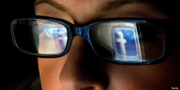 FILE: In this file photo the Facebook Inc. logo is reflected in the eyeglasses of a user in this arranged photo in San Francisco, California, U.S., on Wednesday, Dec. 7, 2011. A Facebook IPO would provide funds to help the social-networking service maintain its expansion and fend off competition from Internet rivals such as Google Inc. and Twitter Inc. Photographer: David Paul Morris/Bloomberg via Getty Images