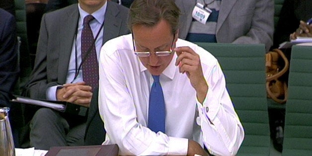 Prime Minister David Cameron wearing glasses answers questions in front of Liaison Select Committee