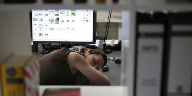 Worker asleep at her desk