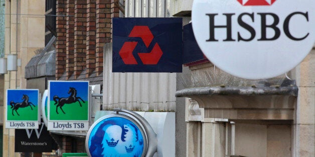 Signs sit outside branches of a Lloyds TSB bank, part of the Lloyds Banking Group Plc, a Barclays Plc bank, a NatWest bank, part of the Royal Bank of Scotland Group Plc (RBS), and a HSBC Holdings Plc bank in Staines, U.K., on Tuesday, Dec. 18, 2012. The European Union is leading a probe into Libor rigging that could see global banks fined as much as 10 percent of their annual revenue. Photographer: Chris Ratcliffe/Bloomberg via Getty Images