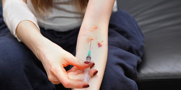 female drug addict with syringe ...