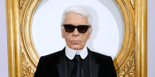 PARIS, FRANCE - OCTOBER 01: (EDITORS NOTE: This image has been retouched) Fashion designer Karl Lagerfeld poses in front of his works before the Chanel show as part of the Paris Fashion Week Womenswear Spring/Summer 2014, held at Grand Palais on October 1, 2013 in Paris, France. (Photo by Bertrand Rindoff Petroff/Getty Images)