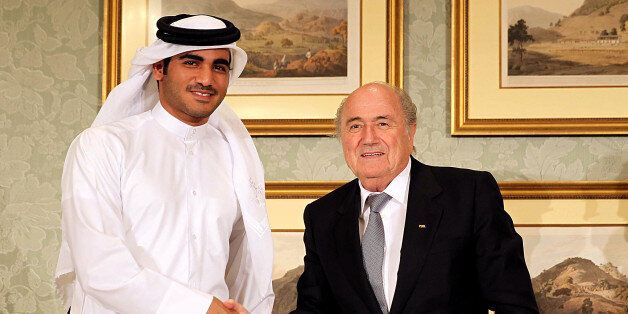 FIFA President Sepp Blatter (R) and the Chairman of Qatar 2022 bid committee Sheik Mohammed bin Hamad al-Thani (L) hold a press conference on November 9, 2013 in Doha, Qatar
