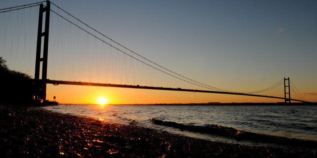 The sun rises behind the Humber Bridge near Hull, East Yorkshire.