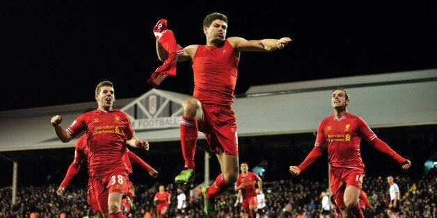 Liverpool's English midfielder Steven Gerrard (C) celebrates scoring their third goal during the English Premier League football match between Fulham and Liverpool at Craven Cottage in London on February 12, 2014. AFP PHOTO / GLYN KIRKRESTRICTED TO EDITORIAL USE. No use with unauthorized audio, video, data, fixture lists, club/league logos or live services. Online in-match use limited to 45 images, no video emulation. No use in betting, games or single club/league/player publications (Ph