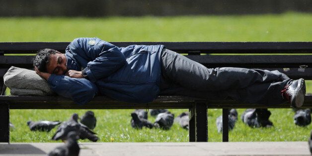 LONDON, ENGLAND - MAY 09: A man sleeps on a bench as groups of Eastern Europeans gather in Marble Arch on May 9, 2013 in London, England. In the early hours of this morning, Scotland Yard and Border Agency officials moved on several groups of Eastern Europeans who have been sleeping rough in the West End, but many had returned by the afternoon. (Photo by Dan Kitwood/Getty Images)