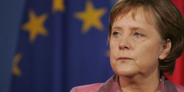 BRUSSELS , BELGIUM - JUNE 28: Angela Merkel, Chancellor of Germany stands by the European flag at the European Summit on June 28, 2012 in Brussels, Belgium.Leaders are meeting to discuss the Multiannual Financial Framework, the European Semester and the European growth agenda. (Photo by Christophe Licoppe/Photonews via Getty Images)