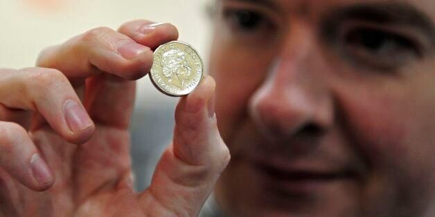 CARDIFF, WALES - MARCH 5: Chancellor of the Exchequer George Osborne, poses with a newly minted one pound coin during a visit to the Royal Mint on March 5, 2011 in Cardiff, United Kingdom. The Conservative Party is in Wales for it's annual spring forum. (Photo by Toby Melville - WPA Pool/GEtty Images)