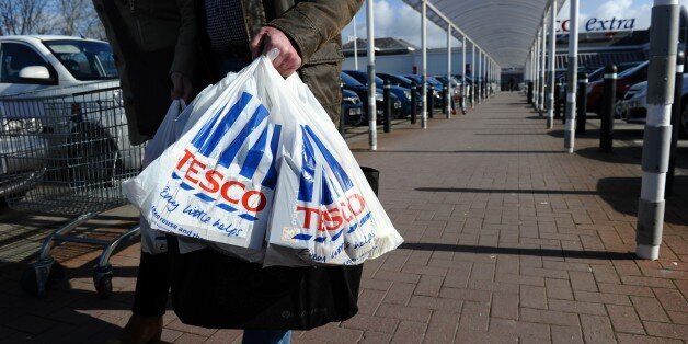 (FILES) In this file picture taken on March 5, 2012 people carry shopping bags through the carpark of a Tesco Extra supermarket in Birkenhead, north-west England. Britain's biggest retailer, supermarket Tesco, looked on course to withdraw from its struggling US business Fresh & Easy as chief executive Philip Clarke on December 5, 2012 said its presence would likely end. AFP PHOTO / PAUL ELLIS (Photo credit should read PAUL ELLIS/AFP/Getty Images)